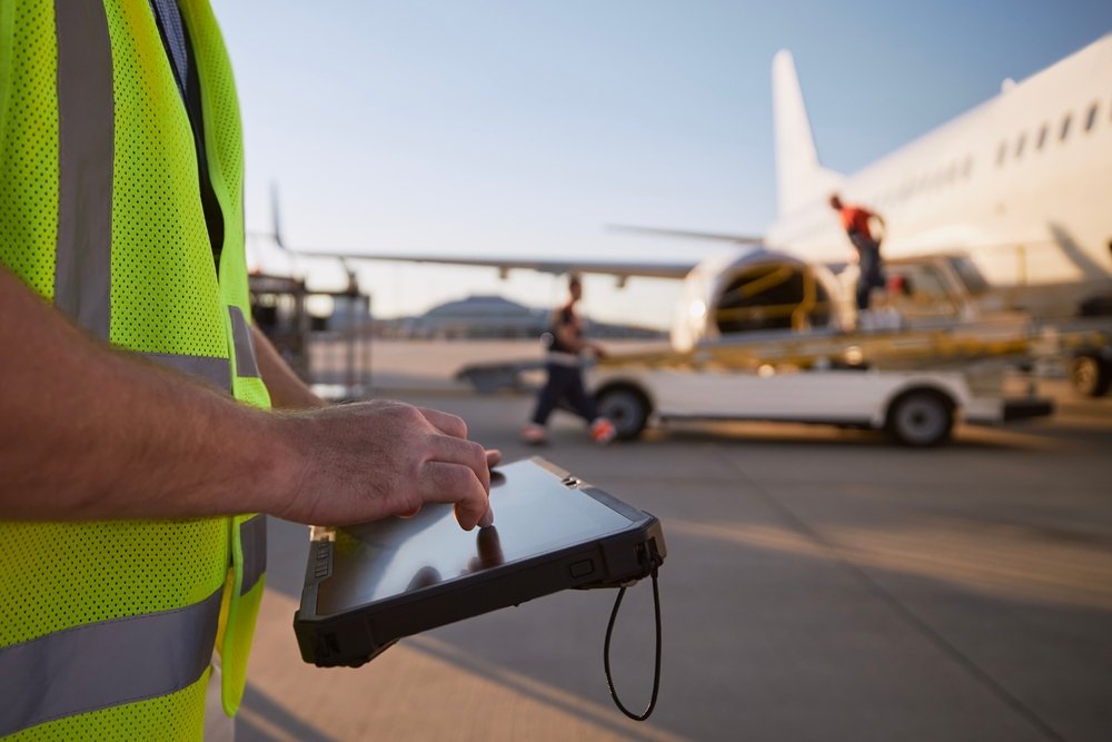 member,of,ground,crew,preparing,airplane,before,flight.,worker,using
